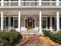 Close-up of the home's entrance, showcasing the front door, sidelights, and brick walkway at 109 Chimeneas Pl, Chapel Hill, NC 27517