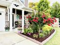 Inviting front porch with rocking chairs and vibrant flower beds, enhancing the curb appeal of the home at 110 Gulley Glen Dr, Garner, NC 27529