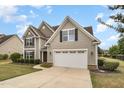 Lovely two-story home with a well-kept lawn and a convenient two-car garage at 121 Stone Nut Trl, Fuquay Varina, NC 27526