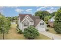Well-maintained home with a spacious two-car garage, lush green lawn and beautiful landscaping at 121 Stone Nut Trl, Fuquay Varina, NC 27526