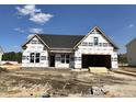 Under-construction single-Gathering home featuring a black roof and an attached two-car garage at 123 Pretty Run Branch Ln, Wendell, NC 27591
