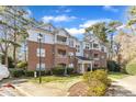 Exterior view of multi-story brick and siding condo complex with manicured lawn at 1700 Tiffany Bay Ct # 303, Raleigh, NC 27609