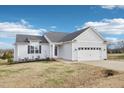Charming white exterior of a two-story home with a two-car garage at 174 Arrow Ln, Middlesex, NC 27557