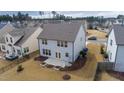 Aerial view of home's backyard, showcasing patio, landscaping, and proximity to neighborhood at 1913 Brodgen Ln, Durham, NC 27703