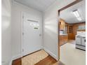 Bright entryway featuring a front door with modern windows and a glimpse of the adjacent kitchen at 1917 Bivins St, Durham, NC 27707