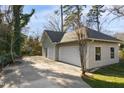 Spacious three-car garage with white doors, offering ample parking and storage space on the property at 2005 Glenwood Ave, Raleigh, NC 27608