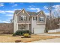 Lovely two-story home with a front porch, complemented by a two-car garage and mature trees at 274 Roaring Creek Dr, Garner, NC 27529