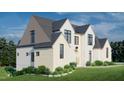 Charming exterior elevation of a two-story home with gray roof and manicured lawn at 297 Colonial Ridge Dr, Pittsboro, NC 27312