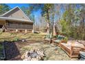 Backyard with stone patio and natural landscaping at 348 Raymond Tharrington Rd, Louisburg, NC 27549