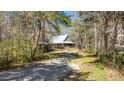 Secluded home nestled among mature trees at 348 Raymond Tharrington Rd, Louisburg, NC 27549