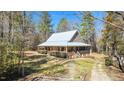 Charming home with welcoming porch and landscaped front yard at 348 Raymond Tharrington Rd, Louisburg, NC 27549