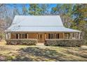 Charming home with a metal roof and covered front porch at 348 Raymond Tharrington Rd, Louisburg, NC 27549