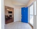Bright foyer with tile flooring, a blue front door and views into the living area of the home at 355 Riverstone Dr, Clayton, NC 27527