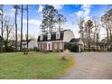 Well-maintained lawn and brick exterior of a home with three dormer windows at 3836 Gloucester Rd, Rocky Mount, NC 27803