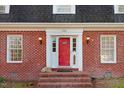 Inviting red brick entrance with red front door and decorative sidelights at 3836 Gloucester Rd, Rocky Mount, NC 27803