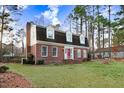 Charming brick home with a red front door and manicured front lawn at 3836 Gloucester Rd, Rocky Mount, NC 27803