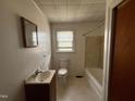 Bathroom with a combination tub and shower, a window and a mirror over the vanity at 4 Second St, Franklinton, NC 27525