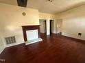 Living room featuring wood floors, a fireplace and multiple entryways at 4 Second St, Franklinton, NC 27525