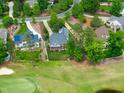 Scenic aerial view of a neighborhood with lush green trees, manicured lawns, and well-maintained homes at 498 Mountain Laurel, Chapel Hill, NC 27517