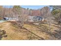 Aerial view of a home nestled on a large lot with mature trees at 520 Log Barn Rd, Pittsboro, NC 27312