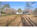 Exterior view of the home with expansive lawn and mature trees at 520 Log Barn Rd, Pittsboro, NC 27312