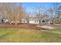 Charming home featuring a sprawling yard with mature trees and landscaping at 520 Log Barn Rd, Pittsboro, NC 27312