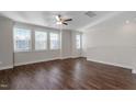 Bright living room with hardwood floors, ceiling fan and many windows providing natural light at 5322 River Reach Dr, Raleigh, NC 27616