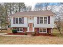 Charming two-story home with brick accents, a well-maintained lawn, and colorful shutters, offering classic curb appeal at 7 Harrigan Ct, Durham, NC 27705