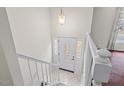 Bright foyer with tiled floor, staircase with white railing, and decorative front door with sidelights at 7 Harrigan Ct, Durham, NC 27705