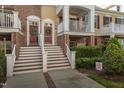 Inviting townhome entrance featuring a classic door, wreath, and well-maintained landscaping at 9211 Calabria Dr # 117, Raleigh, NC 27617
