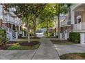Pleasant street view showcasing the townhome's manicured landscaping, sidewalks and inviting facades at 9211 Calabria Dr # 117, Raleigh, NC 27617