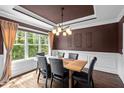 Elegant dining room with hardwood floors, large window, and stylish lighting at 766 Horizon Dr, Pittsboro, NC 27312