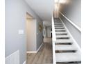 Hallway with carpeted stairs leading to a spacious living area and light gray walls at 7736 Falcon Rest Cir, Raleigh, NC 27615