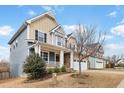 A charming home showcasing a cozy porch, manicured lawn and two-car garage at 8008 Hergety Dr, Raleigh, NC 27603