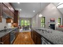 Spacious kitchen featuring granite countertops, stainless appliances, hardwood floors, and an eat-in area at 946 Berry Patch Ln, Pittsboro, NC 27312