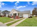 Charming home with an attached garage, showcasing a well-maintained lawn and inviting curb appeal at 112 E Main St, Micro, NC 27555