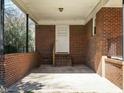 Covered carport featuring brick construction and access to a side entrance at 118 Park Ave, Knightdale, NC 27545