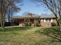 Classic brick home with covered porch and neatly manicured front lawn at 118 Park Ave, Knightdale, NC 27545
