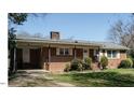 Charming single-story brick home featuring a well-maintained lawn and covered carport at 118 Park Ave, Knightdale, NC 27545