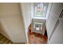 A top-down view of the foyer with hardwood floors, a decorative front door, and paneled walls at 12321 Penrose Trl, Raleigh, NC 27614