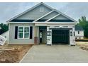 New construction home featuring gray siding, black shutters and a two-car garage with concrete driveway at 130 W Saltgrass Ln, Smithfield, NC 27577