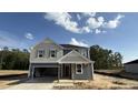 Charming two-story home with a spacious garage and a classic gray and white color scheme at 140 Gobbler Dr, Smithfield, NC 27577