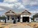 New construction home featuring an attached garage and partially completed brick exterior at 140 W Saltgrass Ln, Smithfield, NC 27577