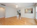 Bright living room with gleaming hardwood floors and ample natural light at 144 Sabiston Ct, Cary, NC 27519