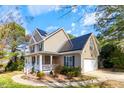Attractive home equipped with solar panels and an attached two-car garage at 153 Dell Meadows Pl, Four Oaks, NC 27524