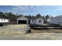 New construction home featuring a covered entrance, open garage and front yard with gravel at 158 Gobbler Dr, Smithfield, NC 27577