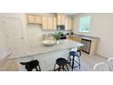 Bright kitchen boasts granite countertops, stainless appliances, and an island with seating at 158 Gobbler Dr, Smithfield, NC 27577