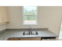 Close up of the kitchen sink featuring stainless steel and granite countertops at 158 Gobbler Dr, Smithfield, NC 27577