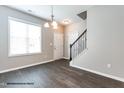 Inviting entryway with hardwood floors, a staircase, and neutral wall paint at 183 W Saltgrass Ln, Smithfield, NC 27577