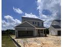 Two-story home featuring a two-car garage and a covered porch, offering curb appeal and functionality at 183 W Saltgrass Ln, Smithfield, NC 27577